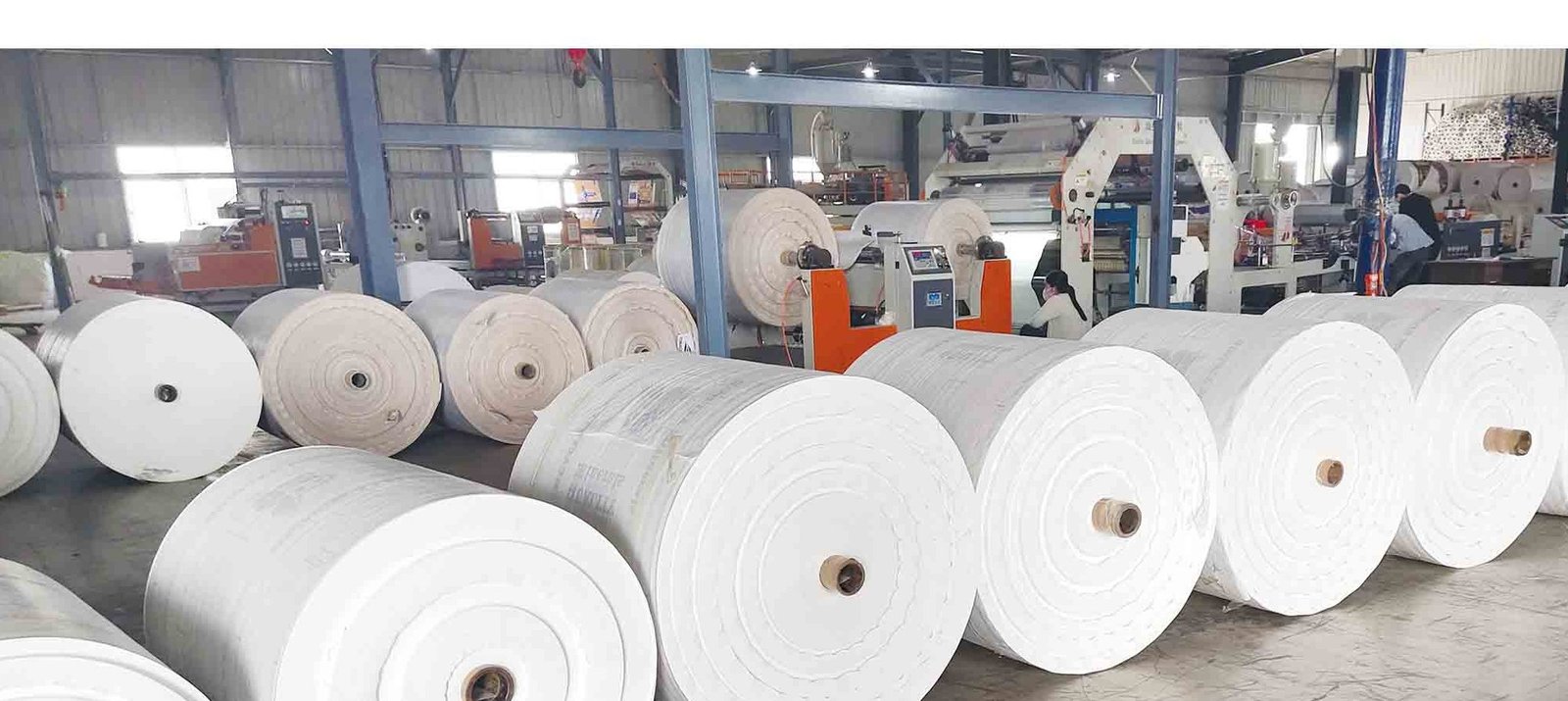Finished rolls of woven polypropylene fabric on the manufacturing floor